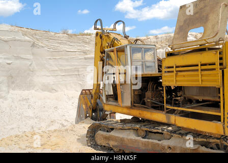 Old yellow dredge in sandy to career Stock Photo