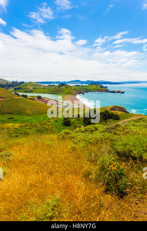 San Francisco in distant background seen from atop the Marin Headlands above Fort Cronkhite and Rodeo Beach Stock Photo