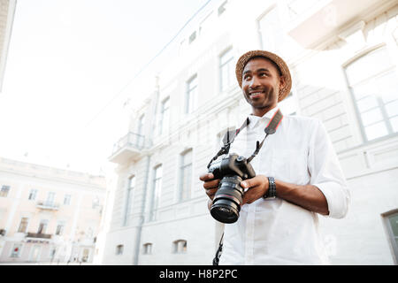 Afro photographer on the street. photo from below Stock Photo
