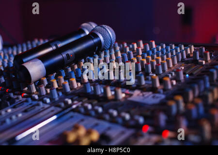 Soundman working on the mixing console in concert hall. Stock Photo