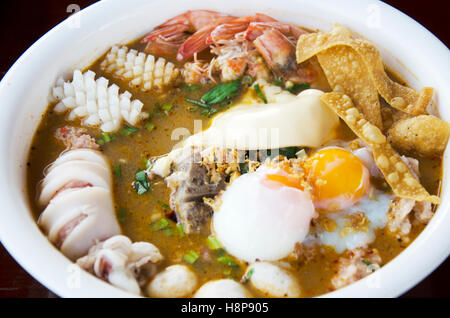 Special noodle spicy soup or noodles tom yam soup thai style with pork and seafood and soft-boiled egg and other seasoning Stock Photo