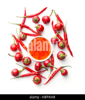 Red chili peppers and chili sauce isolated on white background. Stock Photo