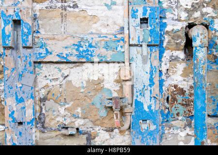Bright colours of flaking paint on a disused foundry wall. Brymbo, Wrexham, Wales. Stock Photo