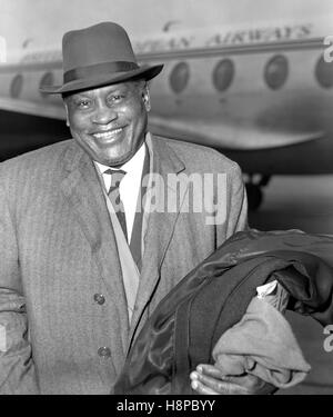 Paul Robeson, who is to play Othello at the Shakespeare Memorial Theatre, Stratford-on-Avon, is pictured on his arrival at London Airport after flying from Paris by BEA liner, completing a journey from Moscow. Stock Photo