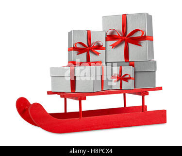 red silver christmas xmas gift present boxes on red wooden santa claus sleigh isolated on white background Stock Photo