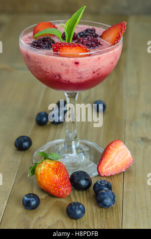 Raspberry smoothie with fresh berries on a wooden table Stock Photo