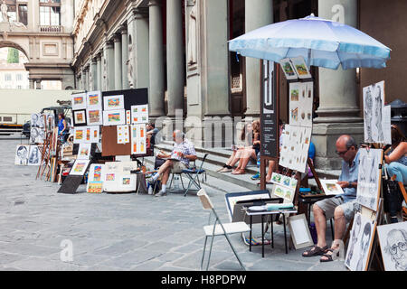Painters working and selling artwork in Florence near Uffizi gallery, Italy