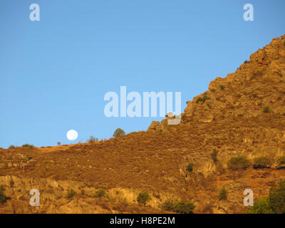 Full moon over mountain in rural Alora Andalusia Stock Photo