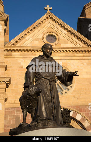 Bronze statue of St Francis with a wolf in front of the Cathedral Basilica of Saint Francis of Assisi Stock Photo