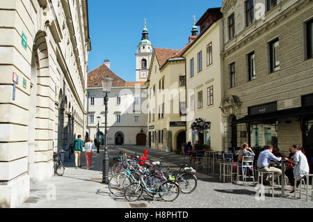 Ljubljana, Slovenia, September 25, 2016: City center, Town Square. Many bike stands on the street, people sit in the pub garden. Stock Photo