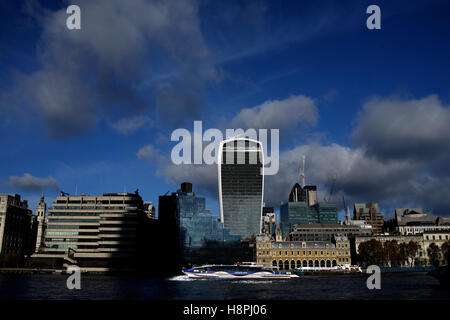 A Thames Clipper riverboat passes in front of the Walkie Talkie building, London