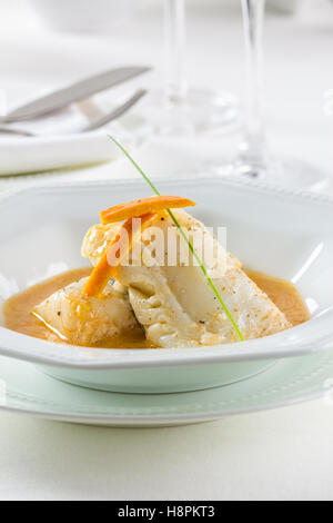 Cod fillets in orange sauce Stock Photo