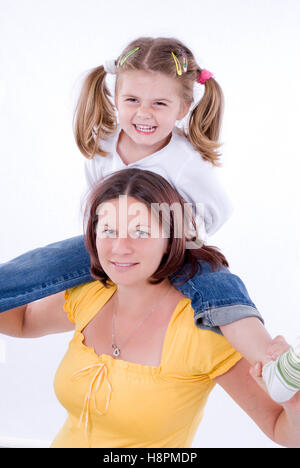 Mother, 25+, with daughter, 4, on her shoulder Stock Photo