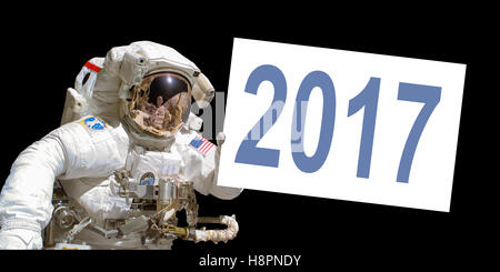 Astronaut in space holding a 2017 white  board - elements of this image are provided by NASA Stock Photo