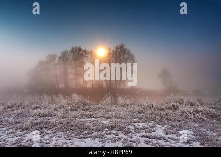 Moonlight in the winter night. Fog and mist on snowy winter river in Belarus. Stock Photo