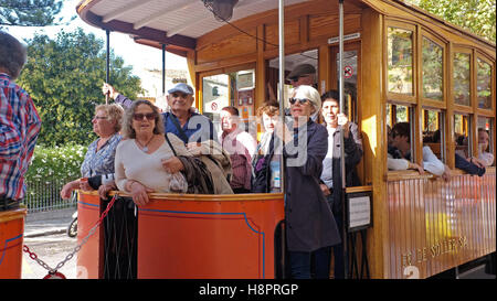 Tourists on the tram that runs from Soller to the port of Soller Stock Photo