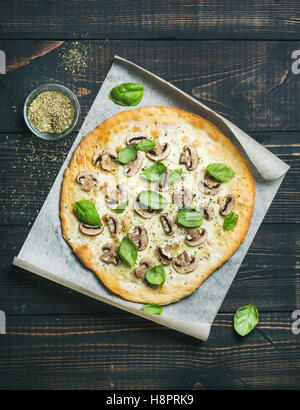 Homemade mushroom pizza with basil leaves and spices in glass Stock Photo