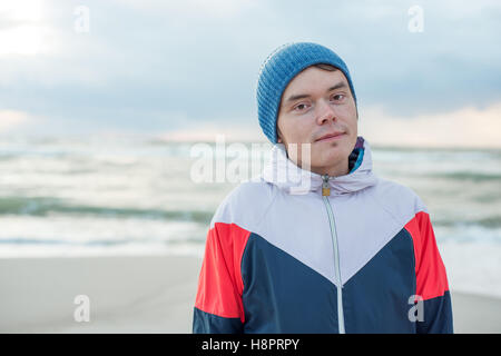 Portrait of young men in sportswear and hat near the sea Stock Photo