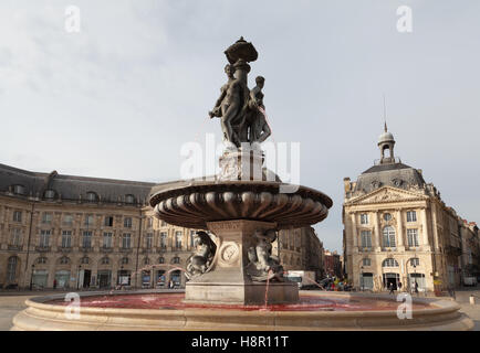 Fountain of the Three Graces with red water on the Place de la Bourse, Bordeaux, Gironde department, France. Stock Photo