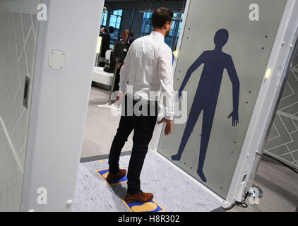 Cologne, Germany. 15th Nov, 2016. A man stands on the control surface 'Easy Security' in a full body scanner in Cologne, Germany, 15 November 2016. Authorities and air travel companies have jointly presented a new system of control for flight guests and luggage at the airport Cologne/Bonn. The security process will be adjusted accordingly, revised and combined with new technology. Photo: Oliver Berg/dpa/Alamy Live News Stock Photo