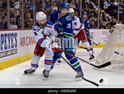 Vancouver, Canada. 15th Nov, 2016. New York Rangers' defenseman Kevin Klein (L) competes for the puck with Vancouver Canuck Brandon Sutter during the regular season match between the New York Rangers and the Vancouver Canucks in Vancouver, Nov. 16, 2016. The New York Rangers won 7-2. Credit:  Andrew Soong/Xinhua/Alamy Live News Stock Photo