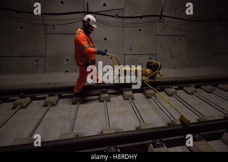 London, UK. 16th November, 2016. Crossrail Stepney Green station in East London. Westbound station. Workers grind and smooth the surface of the recently laid train tracks. Credit:  Guy Corbishley/17�Թ����� Live News Stock Photo
