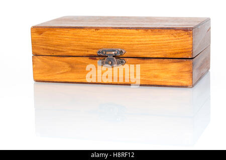 small wooden box isolated on white reflective surface, focus on lock Stock Photo