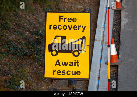 Free recovery await rescue roadworks sign on the M3 in Surrey, England, Britain. Stock Photo