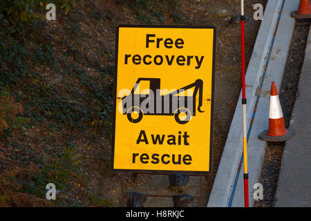 Free recovery await rescue roadworks sign on the M3 in Surrey, England, Britain. Stock Photo