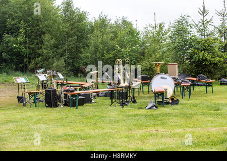 Musical instruments of a music corps, at a festive event, various wind instruments, notes, timpani, on benches, band on a break Stock Photo