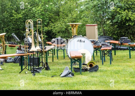 Musical instruments of a music corps, at a festive event, various wind instruments, notes, timpani, on benches, band on a break Stock Photo