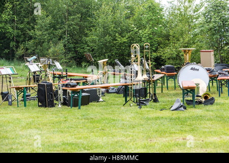 Musical instruments of a music corps, at a festive event, various wind instruments, notes, timpani, on benches, band on a break Stock Photo