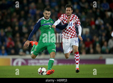 Northern Ireland's Conor McLaughlin (left) and Croatia's Duje Cop (right) battle for the ball during the International Friendly at Windsor Park, Belfast. Stock Photo