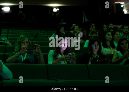 Young woman checking her phone at the movie theater Stock Photo