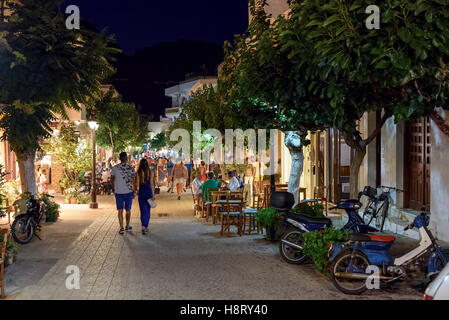 People walking at night street of Paleochora town on Crete island, Greece Stock Photo