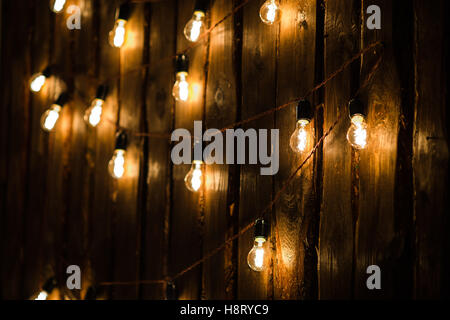 Designer light bulbs on dark wooden background Stock Photo
