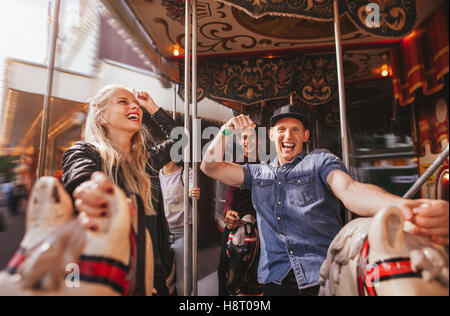 People Having Fun In Carousel Swing Ride At Amusement Park Stock Photo ...