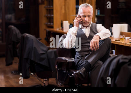 Senior business sitting man talking on mobile phone Stock Photo