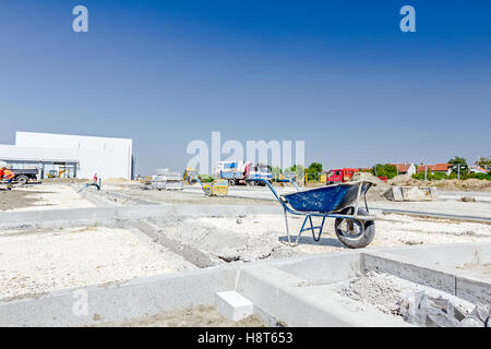 Mortar cart beside newly installed curb stones which are lined and placed for new parking area. Stock Photo