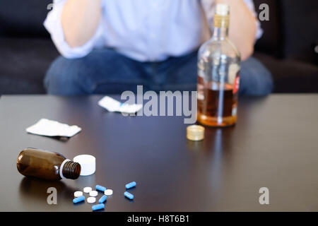 Depressed man mixing alcohol and pills
