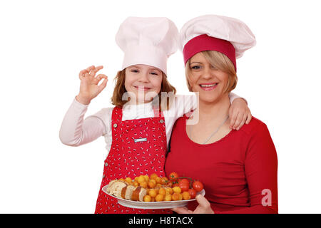 happy mother and daughter cooking Stock Photo