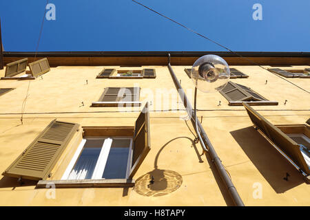 street lamp from the bottom with background the facade of the building in perspective Stock Photo