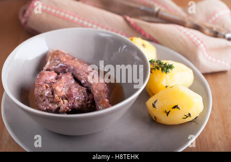 Rabbit meat in winy sauce served on the plate Stock Photo