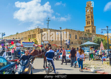 The clock tower of Khan al-Umdan (Inn of Columns) rises over the medieval Akko and is the largest and best preserved khan Stock Photo