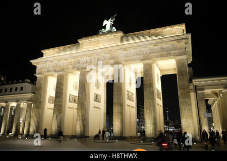 Brandenburg Gate illuminated at night with people in autumn Pariser Platz Berlin Germany Europe EU   KATHY DEWITT Stock Photo