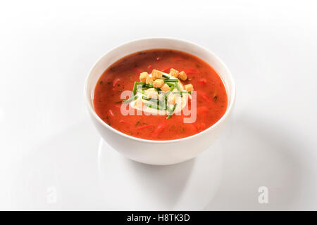 Sweet pepper soup with peppers and sour cream in a white porcelain cup Stock Photo