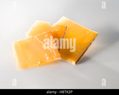 Very old cheese in slices. three square pieces Stock Photo