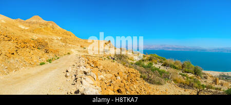 The road into the distance in the mountains of Judean Desert with the view on the Dead Sea, Ein Gedi, Israel. Stock Photo