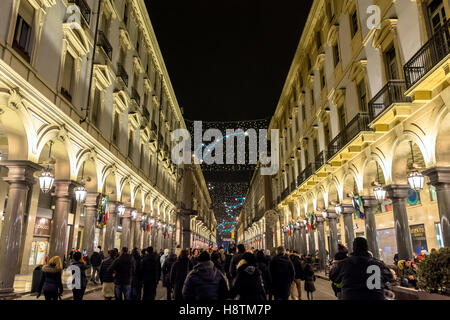 Christmas lights and tourists on new year's eve in Via Roma in Turin, Italy. Stock Photo