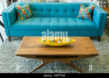 Mid Century blue sofa and wooden coffee table in Palm Springs, California, USA. Stock Photo